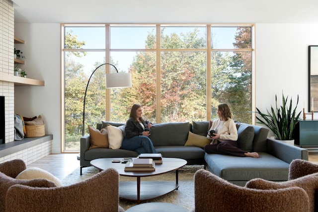 3701 Upton Ave S, Minneapolis, MN 55410 - living room featuring a healthy amount of sunlight, a brick fireplace, and wood finished floors