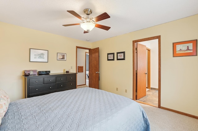 carpeted bedroom featuring baseboards and ceiling fan