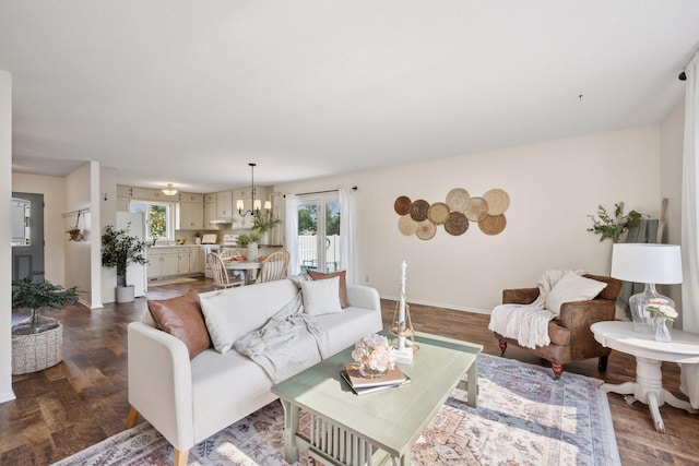11 6th Ave S, Sartell, MN 56377 - living area featuring healthy amount of natural light, dark wood-style floors, and a chandelier