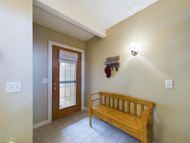 entryway with light tile patterned floors, baseboards, and beamed ceiling