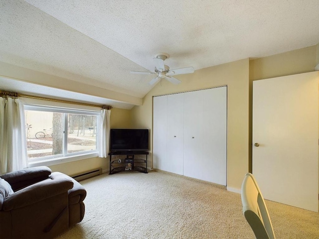 sitting room with a ceiling fan, a textured ceiling, vaulted ceiling, a baseboard heating unit, and carpet flooring