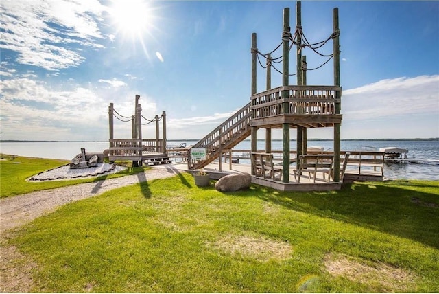 dock area with a yard and a water view