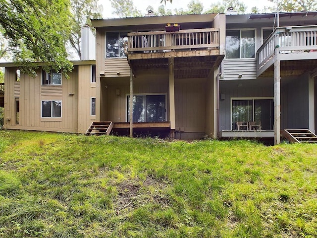 rear view of property with a lawn and a deck