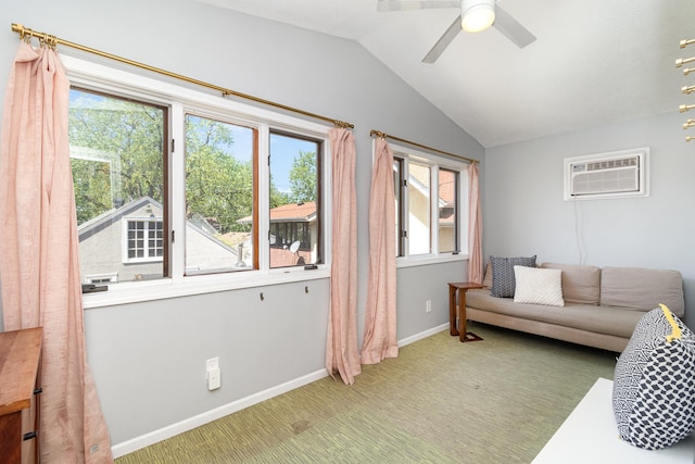living area with a wall mounted AC, healthy amount of natural light, vaulted ceiling, light colored carpet, and a ceiling fan