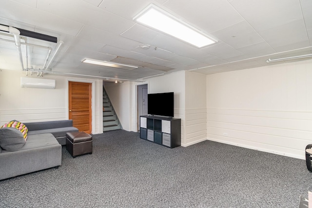 carpeted living room with an AC wall unit and stairs