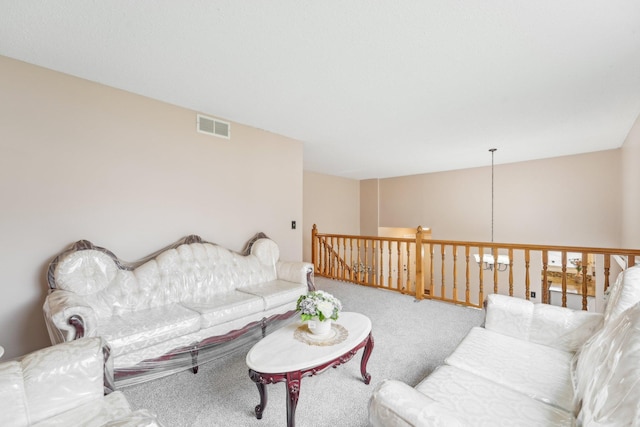 living area featuring carpet floors and visible vents