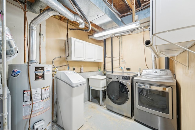 laundry area with water heater, cabinet space, and washer and dryer