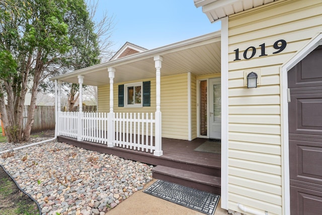 exterior space with fence and covered porch