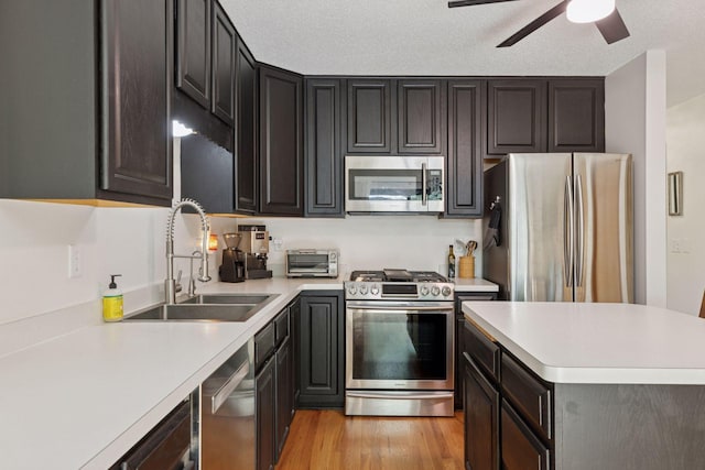 1283 Bidwell St, West Saint Paul, MN 55118 - kitchen with stainless steel appliances, a sink, light countertops, and light wood-style flooring