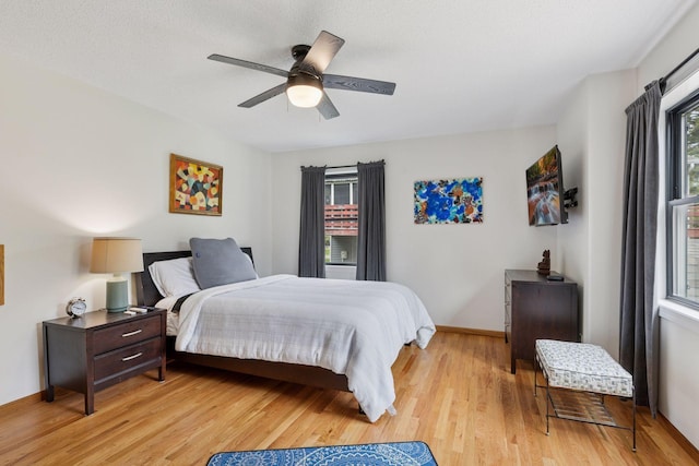 1283 Bidwell St, West Saint Paul, MN 55118 - bedroom with light wood finished floors, ceiling fan, and baseboards