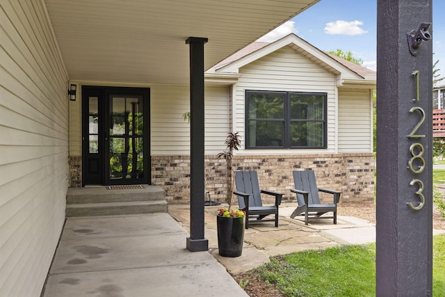 1283 Bidwell St, West Saint Paul, MN 55118 - view of exterior entry with brick siding and a patio area