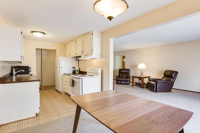 4566 Cedar Lake Rd S Unit 3, Saint Louis Park, MN 55416 - kitchen featuring white appliances, open floor plan, white cabinetry, under cabinet range hood, and a sink