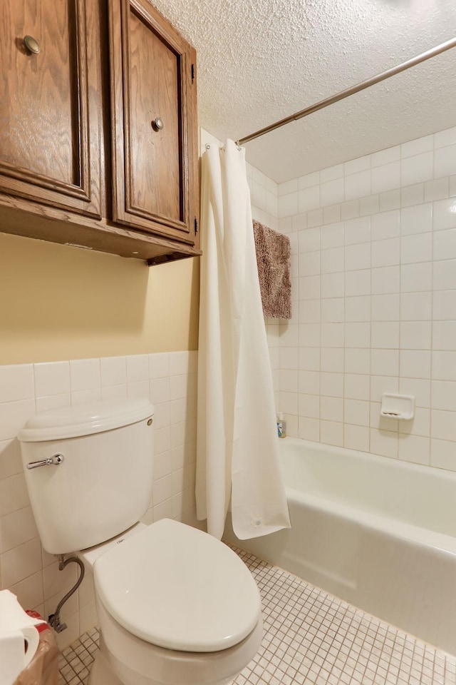4566 Cedar Lake Rd S Unit 3, Saint Louis Park, MN 55416 - full bathroom featuring tile walls, tile patterned flooring, toilet, a wainscoted wall, and shower / bath combo