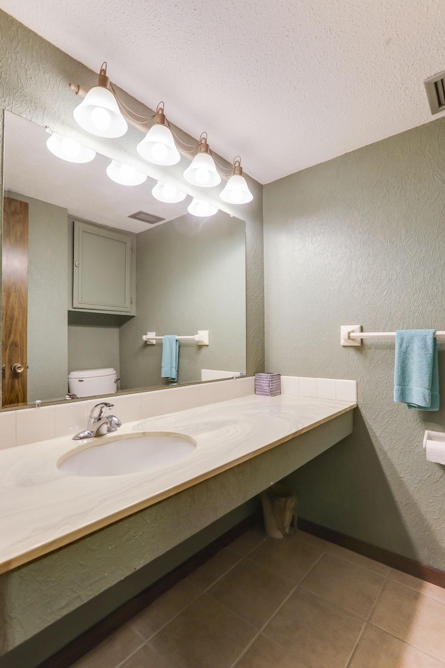 4566 Cedar Lake Rd S Unit 3, Saint Louis Park, MN 55416 - bathroom featuring toilet, tile patterned floors, a textured ceiling, a textured wall, and vanity
