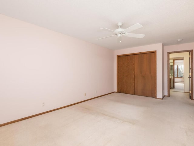 5501 Dewey Hill Rd Unit 233, Edina, MN 55439 - unfurnished bedroom featuring light colored carpet, ceiling fan, baseboards, and a closet