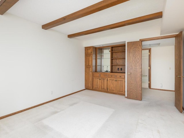 5501 Dewey Hill Rd Unit 233, Edina, MN 55439 - spare room featuring beamed ceiling, baseboards, and light colored carpet