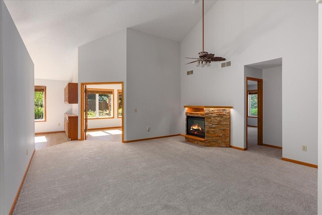 2228 White Pine Ct, Hudson, WI 54016 - unfurnished living room featuring high vaulted ceiling, a fireplace, light carpet, and ceiling fan