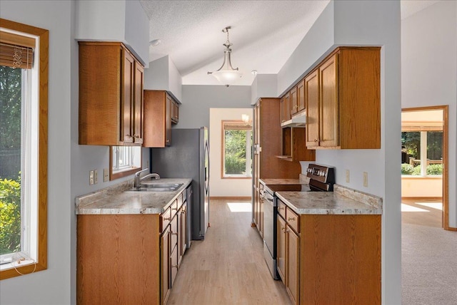 2228 White Pine Ct, Hudson, WI 54016 - kitchen featuring stainless steel range with electric stovetop, under cabinet range hood, brown cabinets, and vaulted ceiling
