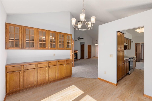 2228 White Pine Ct, Hudson, WI 54016 - kitchen featuring range with electric stovetop, vaulted ceiling, brown cabinets, light wood-style flooring, and a chandelier