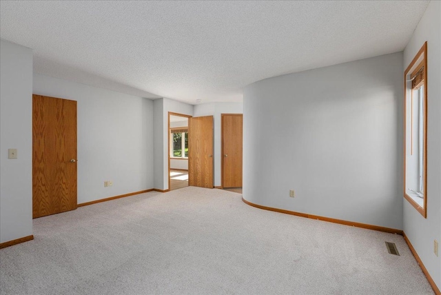 2228 White Pine Ct, Hudson, WI 54016 - carpeted spare room with a textured ceiling and baseboards