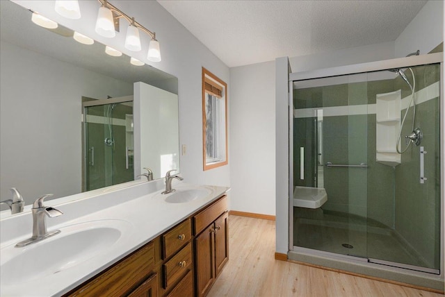2228 White Pine Ct, Hudson, WI 54016 - bathroom with wood finished floors, a stall shower, and double vanity