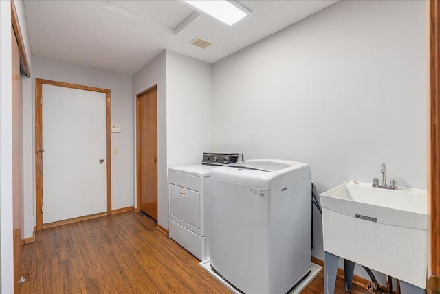 2228 White Pine Ct, Hudson, WI 54016 - laundry area featuring separate washer and dryer and light wood-type flooring