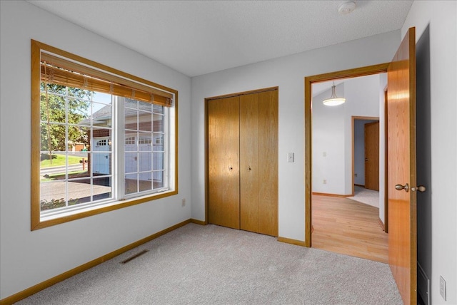 2228 White Pine Ct, Hudson, WI 54016 - unfurnished bedroom featuring light colored carpet and a closet