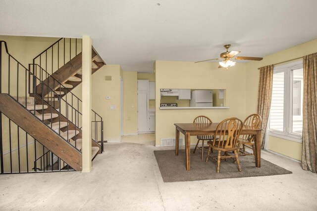 dining area with visible vents, a ceiling fan, and stairs