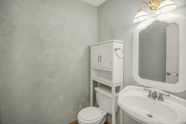bathroom featuring toilet and a sink