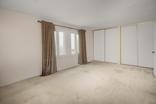 unfurnished room with light carpet