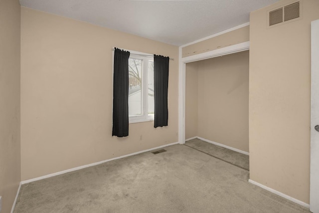 unfurnished bedroom featuring visible vents, carpet, and baseboards