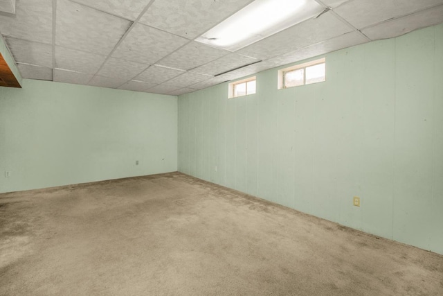 basement with a drop ceiling and carpet floors