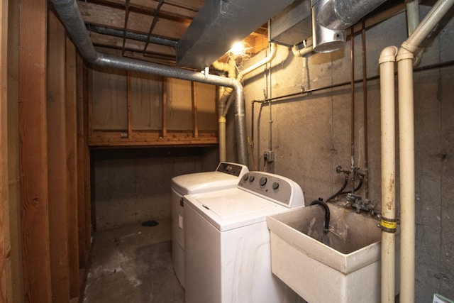 laundry area featuring a sink, laundry area, and independent washer and dryer