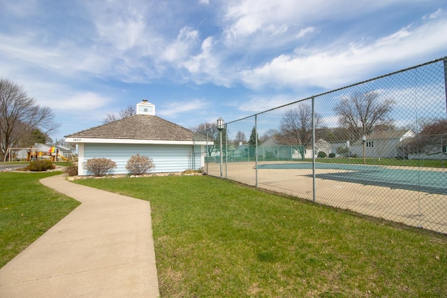 exterior space featuring fence and a lawn