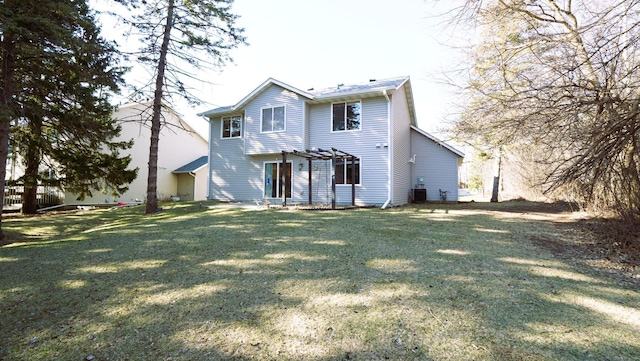 back of house with central AC unit and a yard