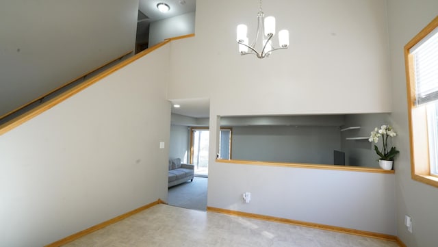 interior space with an inviting chandelier and baseboards