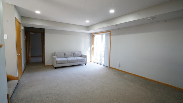 living area with baseboards, recessed lighting, and light carpet