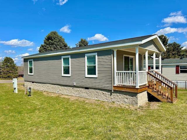 exterior space featuring a front lawn, crawl space, and covered porch