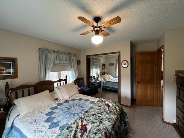carpeted bedroom with a closet, a ceiling fan, and baseboards