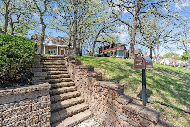 view of green lawn with stairs
