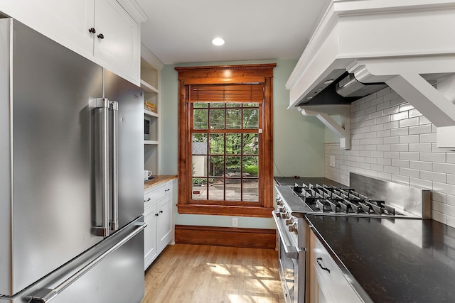 5224 17th Ave S, Minneapolis, MN 55417 - kitchen with high end refrigerator, range, light wood-style floors, tasteful backsplash, and white cabinets