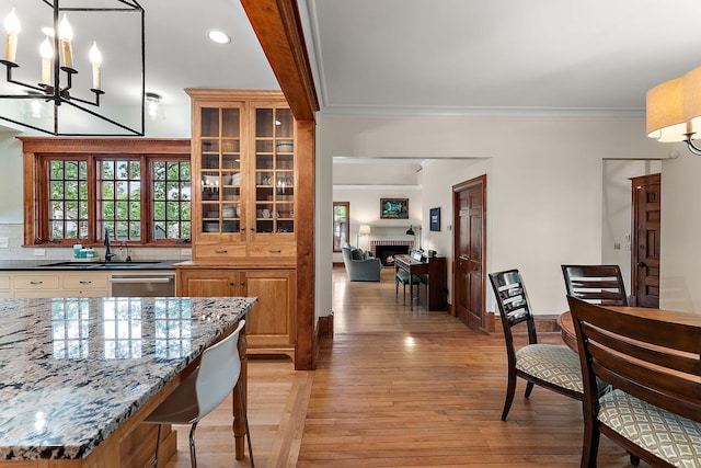 5224 17th Ave S, Minneapolis, MN 55417 - dining area with light wood-style floors, ornamental molding, a chandelier, recessed lighting, and a fireplace