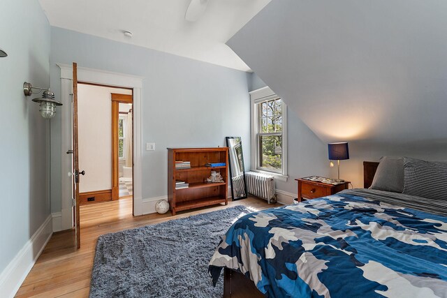 5224 17th Ave S, Minneapolis, MN 55417 - bedroom with radiator heating unit, light wood-style floors, and a ceiling fan