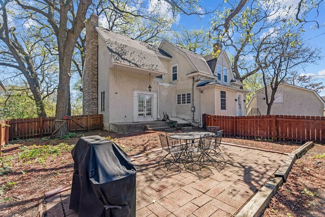 5224 17th Ave S, Minneapolis, MN 55417 - rear view of house with stucco siding, french doors, a patio area, roof with shingles, and a chimney