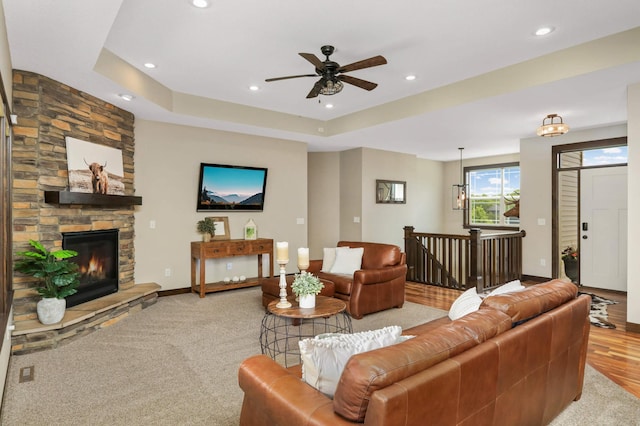 3839 189th Ln NW, Oak Grove, MN 55303 - carpeted living area featuring recessed lighting, ceiling fan, baseboards, a stone fireplace, and a raised ceiling