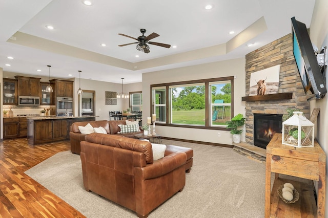3839 189th Ln NW, Oak Grove, MN 55303 - living room featuring recessed lighting, wood finished floors, ceiling fan, a raised ceiling, and a fireplace