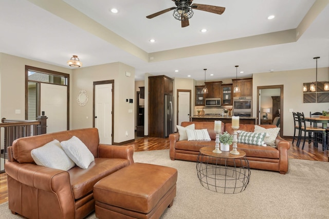 3839 189th Ln NW, Oak Grove, MN 55303 - living area featuring light wood finished floors, a ceiling fan, recessed lighting, baseboards, and a raised ceiling