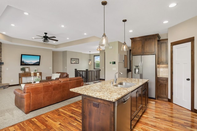 3839 189th Ln NW, Oak Grove, MN 55303 - kitchen with a sink, appliances with stainless steel finishes, light wood-style flooring, ceiling fan, and open floor plan