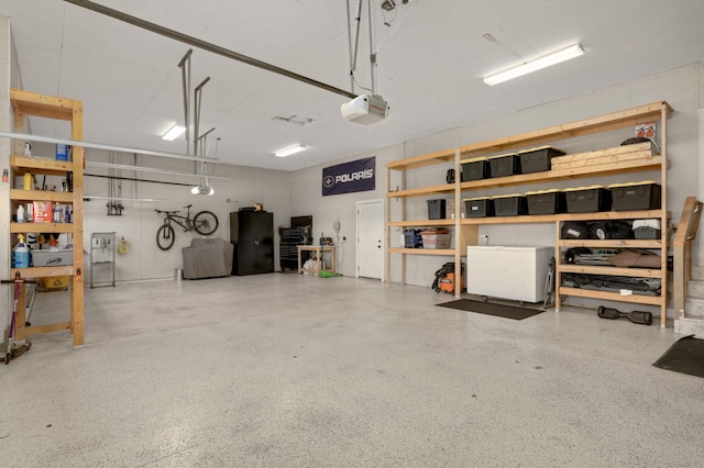 3839 189th Ln NW, Oak Grove, MN 55303 - garage featuring a garage door opener and freestanding refrigerator