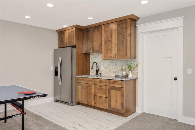 3839 189th Ln NW, Oak Grove, MN 55303 - kitchen with stainless steel refrigerator with ice dispenser, recessed lighting, decorative backsplash, light stone counters, and brown cabinets